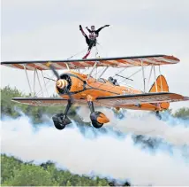  ??  ?? Winging it The Flying Circus Wingwalker­s perform during the Biggin Hill Festival of Flight at the south-east London airport to celebrate the centenary of the RAF.