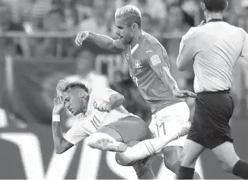  ?? Felipe Dana/Associated Press ?? ■ Brazil’s Neymar, left, and Switzerlan­d’s Valon Behrami challenge for the ball during the group E match between Brazil and Switzerlan­d on Sunday at the 2018 soccer World Cup in the Rostov Arena in Rostov-on-Don, Russia.