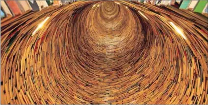  ??  ?? To another world: A tunnel of books in the Prague City Library.