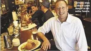  ??  ?? Lafrieda tries a Black Label Burger at Minetta Tavern.