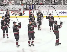  ?? PHOTOS BY MICHAEL CHOW/THE REPUBLIC ?? Coyotes players applaud their fans after defeating the Edmonton Oilers 5-2 during their final home game at Mullett Arena.