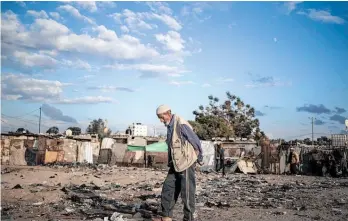  ?? Photo / AP ?? A Palestinia­n elderly man walks near Khan Younis Refugee camp in the Gaza Strip.