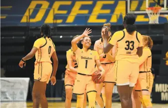  ?? Kayla Lawrence / Cal Athletics ?? Cal’s Leilani McIntosh (1), who scored 21 points, celebrates with her teammates after the Bears beat Arizona State at Haas Pavilion on Sunday for their first win of the season.
