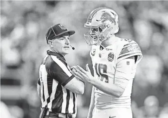  ?? ?? Lions quarterbac­k Jared Goff talks to a referee regarding offensive tackle Taylor Decker’s two-point conversion catch against the Cowboys being called illegal touching.