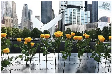  ?? Picture: ANGELA WEISS/AFP / GETTY ?? THE DAY THE WORLD CHANGED: Flowers on the 9/11 Memorial and Museum in New York City