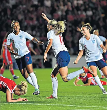  ??  ?? First of three: Toni Duggan celebrates scoring the opening goal as England secured their place at next year’s tournament