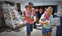  ?? THOMAS CORDY / THE PALM BEACH POST 2017 ?? Residents of Santa Isabel, Puerto Rico, pick up food, water and juice at a distributi­on point in October.