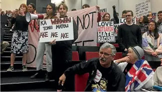  ?? ALAN APTED/STUFF ?? Protesters at Don Brash’s speech at the Auckland University debate. For a time, it appeared Brash would not be able to speak as the protesters sang and shouted over him.