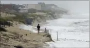  ?? AP PHOTO/GERRY BROOME ?? Heavy surf crashes the dunes at high tide in Nags Head, N.C., Thursday, Sept. 13, as Hurricane Florence approaches the East Coast.