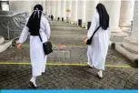  ?? —AFP ?? VATICAN: Nuns go through the security area across markings on the ground under the colonnades to access St Peter’s Square Basilica yesterday in The Vatican during the lockdown aimed at curbing the spread of the COVID-19 infection.