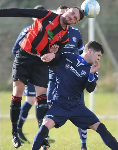  ?? Picture: Ken Finegan ?? Keith Finnegan, Bellurgan, rises highest against Stuart Osborne, Ardee Celtic.