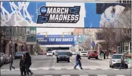  ?? Darron Cummings / Associated Press ?? March Madness banners for the NCAA college basketball tournament cover crosswalks in downtown Indianapol­is on Wednesday.