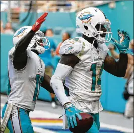  ?? WILFREDO LEE / ASSOCIATED PRESS ?? Dolphins wide receiver Jarvis Landry (14) has at times seemed upset when passes aren’t finding him more often and accurately.