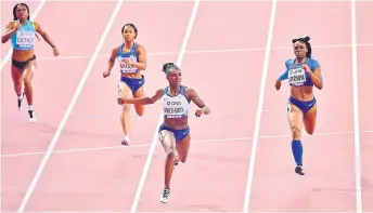 ?? — AFP photo ?? Dina Asher-Smith (second right) crosses the finish line to win the Women’s 200m final at the 2019 IAAF Athletics World Championsh­ips at the Khalifa Internatio­nal stadium in Doha.