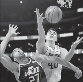  ?? Mark J. Terrill Associated Press ?? JAZZ CENTER RUDY GOBERT, left, and Lakers center Ivica Zubac, battle for a rebound during the first half en route to Utah’s win.