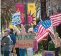  ?? TNS ?? Protesters hold signs at an anti-vaccine protest on March 9, 2022, next to Santa Clara University in Santa Clara, California.