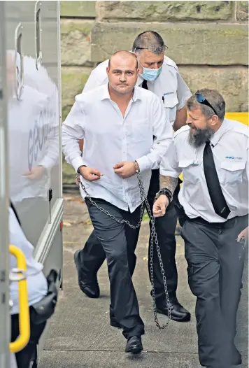  ??  ?? Former Barnsley FC footballer Steven Bennett is led away in handcuffs from Chester Crown Court, where he was jailed for five years