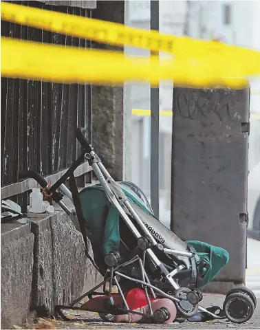  ?? STAFF PHOTOS BY STUART CAHILL ?? DEVASTATIN­G SCENE: A crumpled stroller and doll lie on the sidewalk, above, after a 3-yearold boy was killed yesterday when the stroller was struck by a van, right, that collided with a car, top photo, at the intersecti­on of L and East Sixth streets in...