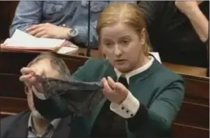  ??  ?? Ruth Coppinger TD holds up a thong in the Dáil in protest at ‘rape myths’.