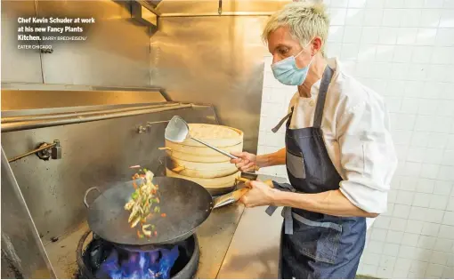  ?? BARRY BRECHEISEN/ EATER CHICAGO ?? Chef Kevin Schuder at work at his new Fancy Plants Kitchen.