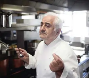  ?? STEPHANE DE SAKUTIN/AFP ?? French chef Guy Savoy works in the kitchen of his restaurant at the Hotel de la Monnaie in Paris in May 2015.