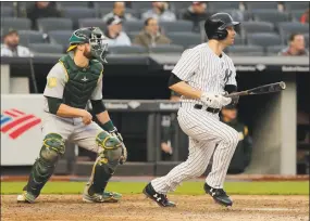  ?? Julie Jacobson / Associated Press ?? Neil Walker, right, watches his base hit to center field to drive in the winning run against the Athletics during the 11th inning on Saturday.