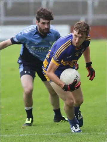  ??  ?? St Anne’s’ Kevin Hannigan tries to stop Gusserane’s Adrian Redmond.