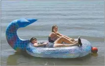  ?? ALEX HORVATH / THE CALIFORNIA­N ?? Shirley and Haylee Haney of Bakersfiel­d enjoy a warm spring day on their floating raft at the Buena Vista Aquatic Recreation Area on Friday afternoon. Friday’s high temperatur­e was 86, while Saturday’s high reached 90.