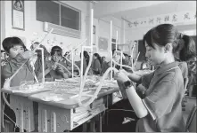  ??  ?? Left: Students join a science class to make paper rockets to launch into the sky, as part of a program to stir an interest in science, technology and mathematic­s among female students, in Lixian County No 1 Middle School in Longnan city, Gansu province.