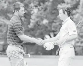  ?? Rex C. Curry / Dallas Morning News ?? Michael Cotton, left, of Katy receives a congratula­tory handshake from Grant Bennett of Lewisville on the 18th green after wrapping up his victory at the Texas Amateur Championsh­ip on Sunday at Dallas’ Bent Tree Country Club.