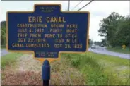  ?? JOHN CLIFFORD — THE DAILY SENTINEL (VIA AP) ?? In this June 28, 2017, photo, a sign on route 49⁄46 in Rome, N.Y., marks the spot where digging for constructi­on on the Erie Canal began. This Fourth of July marks the 200th anniversar­y of the ceremonial first digging for the constructi­on of the Erie...