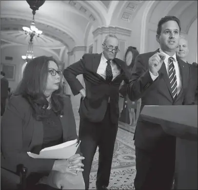  ?? The Associated Press ?? SENATORS SPEAK: From left, Sen. Tammy Duckworth, D-Ill., Senate Minority Leader Chuck Schumer, D-N.Y., Sen. Brian Schatz, D-Hawaii, and Sen. Chris Van Hollen, D-Md., speak following a weekly strategy session, Tuesday on Capitol Hill in Washington.