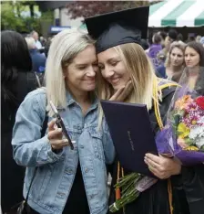  ?? PAUL CONNORS PHOTOS / BOSTON HERALD ?? THE TASSEL WAS WORTH THE HASSLE: Curry College graduate of nursing Jaclyn Krikorian, right, is congratula­ted by her friend Kellyn Dyer, left, after a commenceme­nt ceremony Sunday at the Xfinity Center in Mansfield.