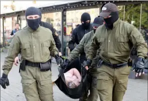  ?? (AFP) ?? Law enforcemen­t officers carry a woman to be transporte­d by ambulance during a protest against the Belarus presidenti­al election results, in Minsk on Saturday.