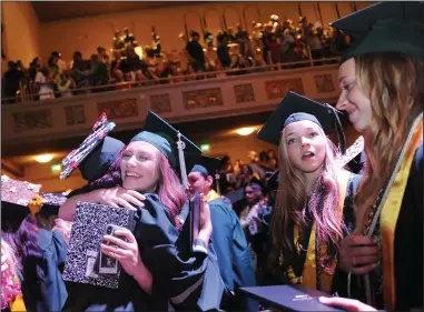  ?? BEA AHBECK/NEWS-SENTINEL ?? Graduates hug each other at the end of the Liberty Ranch commenceme­nt ceremony on Thursday at the Sacramento Memorial Auditorium.