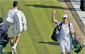  ??  ?? Big Sam: American Sam Querrey celebrates his victory over Novak Djokovic, who is seen leaving Centre Court (left)