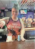  ?? ROBERT BELL/ROCHESTER DEMOCRAT AND CHRONICLE ?? Amanda Ryan pours drinks at the S&T Lounge.