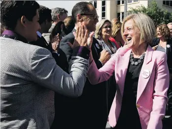  ?? DAVID BLOOM ?? Alberta Premier Rachel Notley, right, high-fives Strathcona-Sherwood Park MLA Estefania Cortes-Vargas at a news conference announcing the federal government’s purchase of the Trans Mountain Pipeline Tuesday.