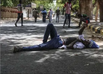  ?? PHOTO ?? A protester takes a rest in a street leading to the sitin outside military headquarte­rs, in Khartoum, Sudan, on Tuesday. AP