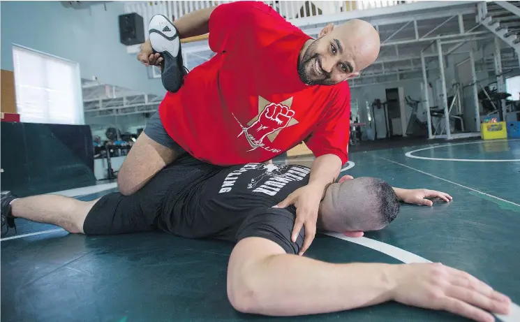  ?? JASON PAYNE ?? Arjan Bhullar, sparring with Brad Hildebrand­t, is now trying his hand at MMA after signing with the UFC, making him the first Indo-Canadian fighter on the circuit.