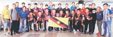  ??  ?? Miri FA U16 team players greeted by Lukanisman (back row, middle) and other supporters at Miri Airport yesterday.