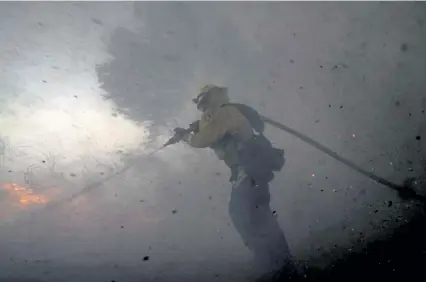  ?? Jae C. Hong, The Associated Press ?? A firefighte­r battles the Silverado fire on Monday in Irvine, Calif.