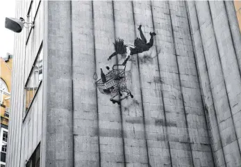  ?? FOTOS: DPA ?? Dieses Bild des anonymen Graffiti-Künstlers Banksy ist derzeit noch in London zu sehen.