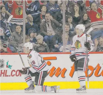  ?? | AP ?? Jonathan Toews (19) and Patrick Kane whoop it up after Toews’ goal in the second period. Kane scored in the first period.