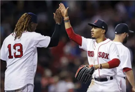  ?? CHARLES KRUPA — THE ASSOCIATED PRESS ?? Mookie Betts, right, is congratula­ted by Hanley Ramirez after Boston’s win over the Twins on Thursday night.