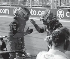  ?? HASAN BRATIC Hasan Bratic/picture-alliance/dpa/AP Images ?? Charles Leclerc receives congratula­tions from teammate Carlos Sainz Jr. after qualifying Saturday in Miami Gardens. Leclerc was first and Sainz second.