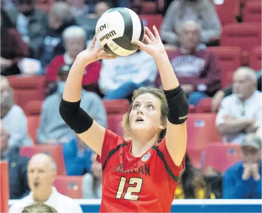  ?? MICHAEL GARD/POST-TRIBUNE ?? Andrean’s Maddie Kmetz sets the ball during the Class 2A state championsh­ip match against Western Boone at Ball State’s Worthen Arena in Muncie on Nov. 6.