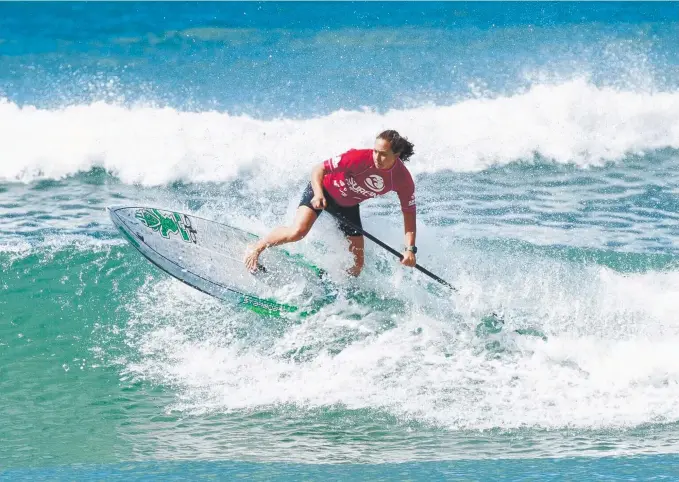  ??  ?? Stand Up star Shakira Westdorp shows off the form that took her to the world title, which she won in Fiji last year (below) at the infamous Cloudbreak. Main Picture: SURFING QUEENSLAND