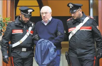  ?? Alessandro Fucarini / AFP / Getty Images ?? Settimino Mineo, the new head of the Sicilian mafia, is escorted by police after his arrest, in Palermo, Sicily. Wednesday’s raids were against the powerful ‘ndrangheta crime group.