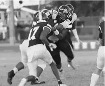  ?? CHRIS HAYS/ORLANDO SENTINEL ?? Ocoee defensive tackle Jordan Phillips zeroes in on Wekiva quarterbac­k Junior Muratovic (11) during Ocoee’s 24-20 victory Friday night.